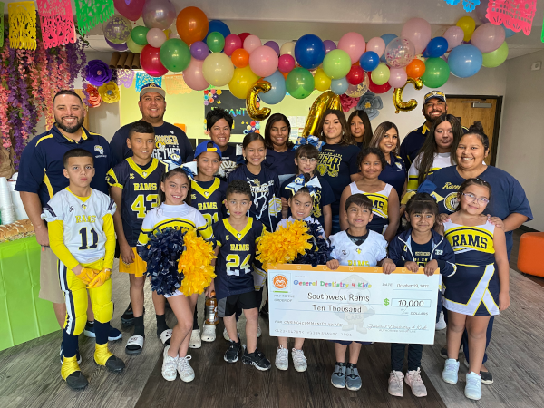 Caring 4 Community Contest Southwest Rams Check Hand Off