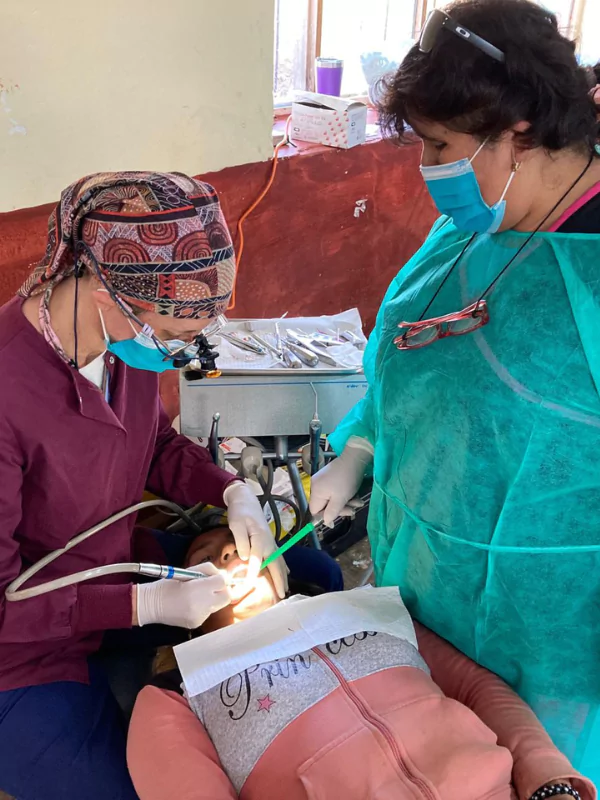 Dr Amy with patient Dr Amy helping patients in Peru