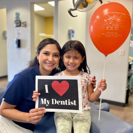 Our Patients Love Us! Dentist & Patient Holding Baloon