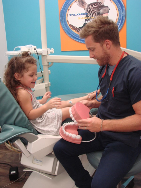 Pediatric Dentist with Patient Doctor Owner with Patient